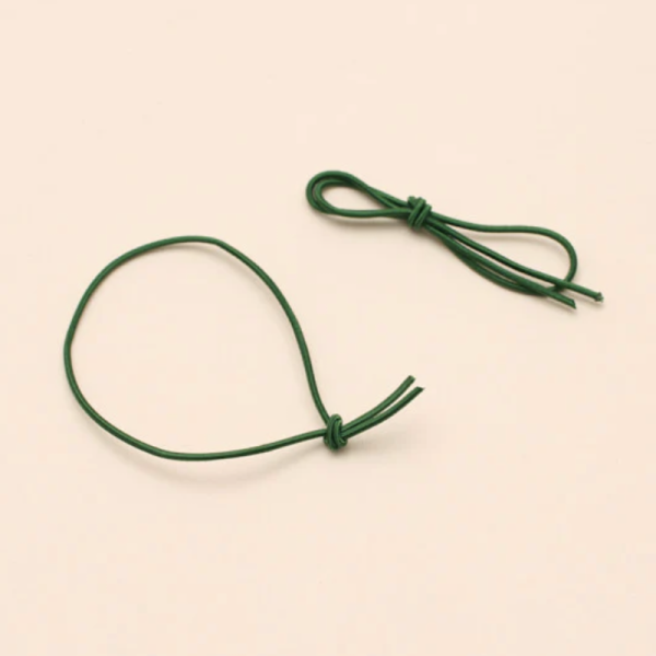 A pair of spare green elastic ribbons for the Pocket Folio.