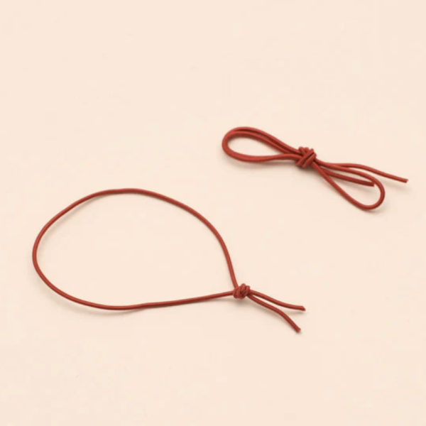 A pair of spare red elastic ribbons for the Pocket Folio.