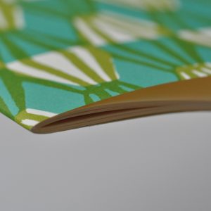 A detail of Exercise Book with Sap Green and Turquoise patterned cover