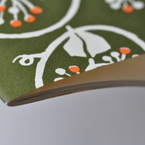 detail of Exercise Book with Swamp Green and Orange patterned cover